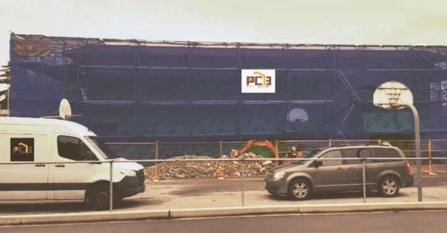 Pacific Custom Builders site sign at a job site